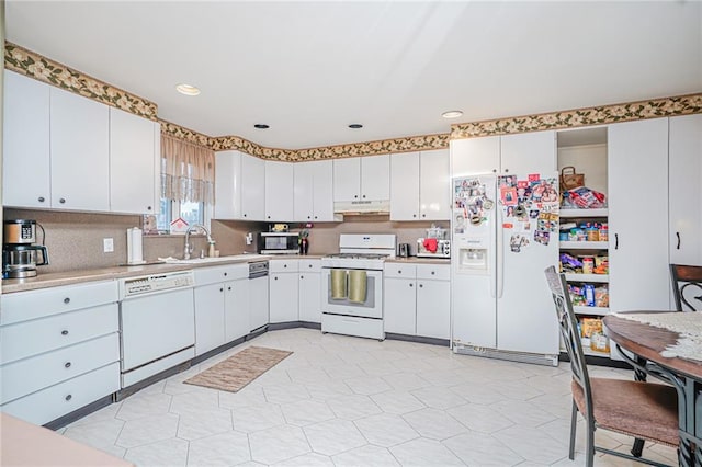 443 Ridgewood Ave, Staten Island, NY 10312 - kitchen featuring white appliances, under cabinet range hood, light countertops, white cabinets, and recessed lighting
