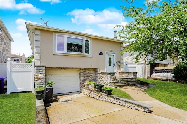 731 Stafford Ave, Staten Island, NY 10309 - view of front of property with stucco siding, stone siding, an attached garage, and concrete driveway