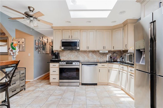731 Stafford Ave, Staten Island, NY 10309 - kitchen with stainless steel appliances, dark countertops, a skylight, backsplash, and recessed lighting