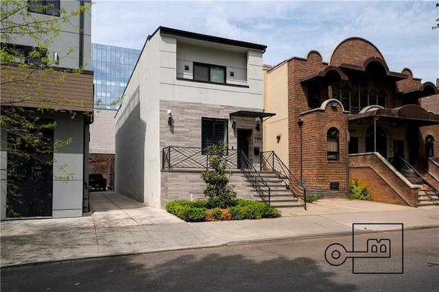 1168 E 12th St, Brooklyn, NY 11230 - view of front of home featuring stucco siding, stairway, and stone siding