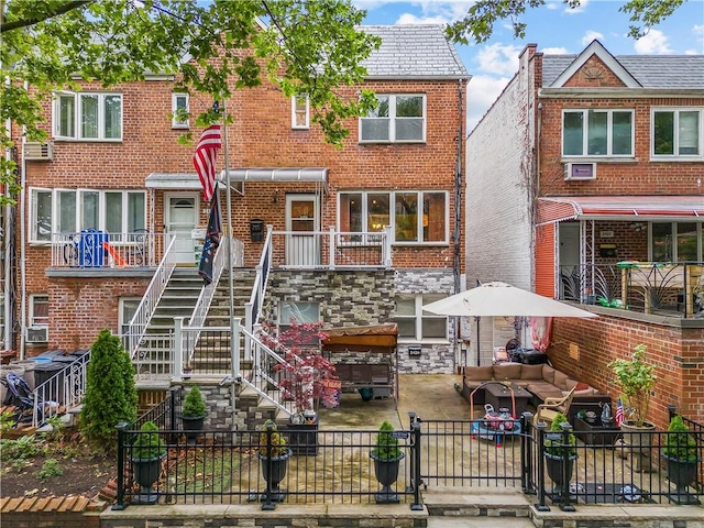 2426 Bragg St, Brooklyn, NY 11235 - multi unit property featuring stairs, a fenced backyard, brick siding, and a patio