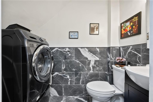 2426 Bragg St, Brooklyn, NY 11235 - bathroom with vanity, tile walls, and washer / dryer