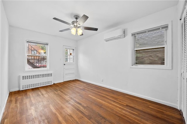 2426 Bragg St, Brooklyn, NY 11235 - spare room with radiator, a wall mounted AC, wood finished floors, and ceiling fan