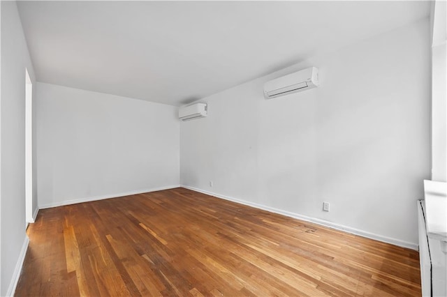 2426 Bragg St, Brooklyn, NY 11235 - spare room featuring a wall unit AC and hardwood / wood-style floors