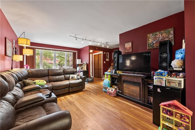 2426 Bragg St, Brooklyn, NY 11235 - living area featuring light wood-type flooring and rail lighting