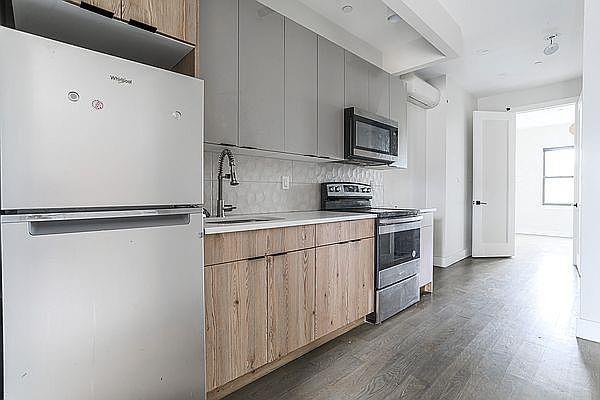 1281 Nostrand Ave, Brooklyn, NY 11226 - kitchen featuring stainless steel appliances, dark wood-type flooring, backsplash, modern cabinets, and gray cabinets