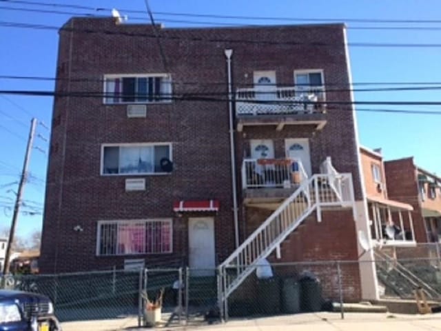 2301 W 7th St, Brooklyn, NY 11223 - view of front of property featuring a fenced front yard and brick siding