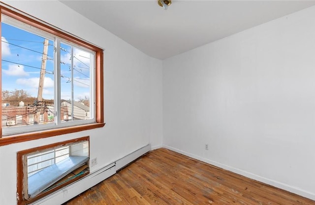 2301 W 7th St, Brooklyn, NY 11223 - empty room featuring baseboard heating and wood finished floors