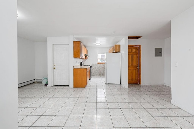 8309 19th Ave, Brooklyn, NY 11214 - kitchen featuring freestanding refrigerator, range with gas stovetop, brown cabinetry, a baseboard heating unit, and light countertops