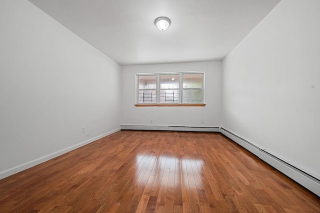 8309 19th Ave, Brooklyn, NY 11214 - spare room with a baseboard radiator and wood finished floors