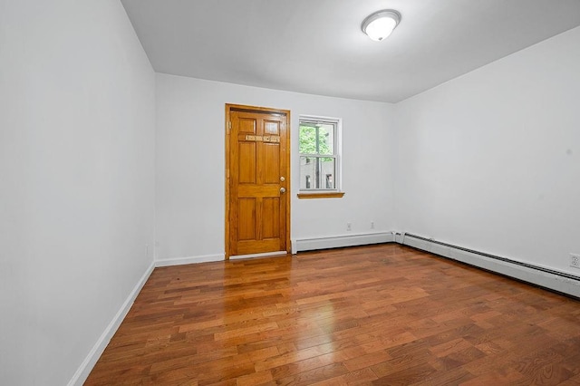 8309 19th Ave, Brooklyn, NY 11214 - spare room with a baseboard heating unit and wood finished floors