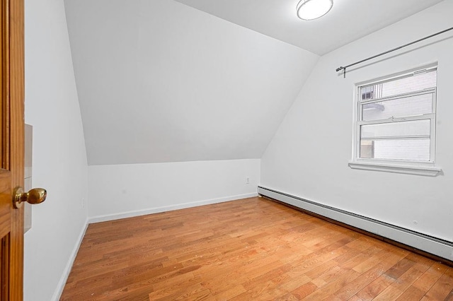 8309 19th Ave, Brooklyn, NY 11214 - bonus room with a baseboard radiator, lofted ceiling, and light wood-type flooring
