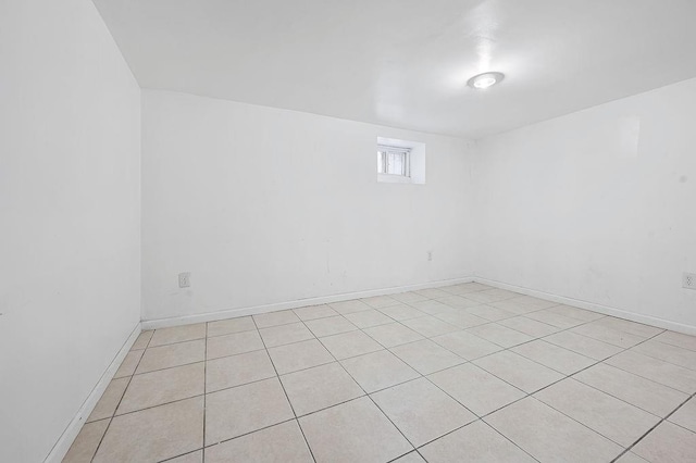 8309 19th Ave, Brooklyn, NY 11214 - spare room with light tile patterned floors and baseboards