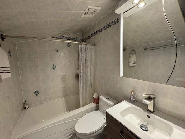 3541 Shore Pkwy Unit B2, Sheepshead Bay, NY 11235 - bathroom with tile walls, shower / bath combo with shower curtain, vanity, and tasteful backsplash