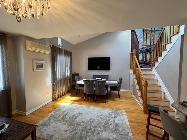 3541 Shore Pkwy Unit B2, Sheepshead Bay, NY 11235 - dining space featuring a wall mounted AC, a chandelier, vaulted ceiling, stairway, and light wood-type flooring