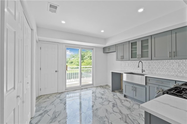 795 Father Capodanno Blvd, Staten Island, NY 10305 - kitchen with gray cabinetry, light marble finish floors, light stone counters, glass insert cabinets, and recessed lighting