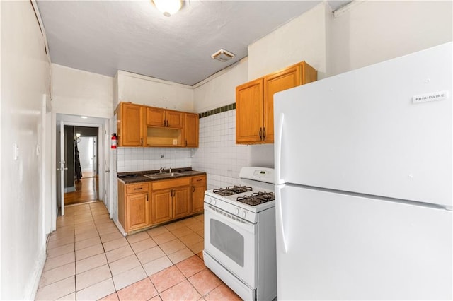 317 Pennsylvania Ave, Brooklyn, NY 11207 - kitchen with white appliances, light tile patterned floors, dark countertops, open shelves, and tasteful backsplash