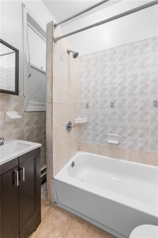 317 Pennsylvania Ave, Brooklyn, NY 11207 - bathroom featuring tile walls, bathtub / shower combination, vanity, and tile patterned floors