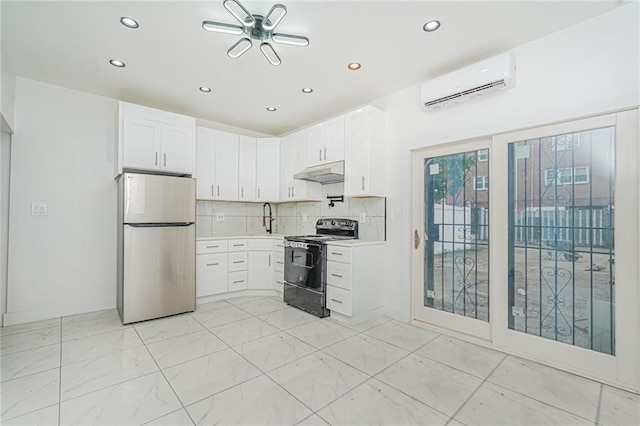 590 E 83rd St, Brooklyn, NY 11236 - kitchen with freestanding refrigerator, range with electric stovetop, a wall unit AC, recessed lighting, and under cabinet range hood