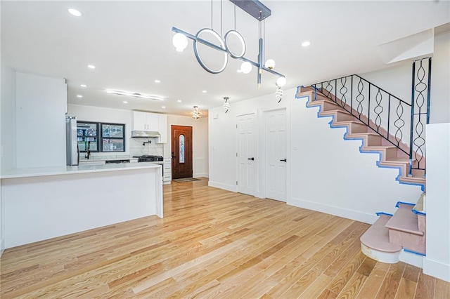 590 E 83rd St, Brooklyn, NY 11236 - entryway featuring stairway, light wood finished floors, and recessed lighting