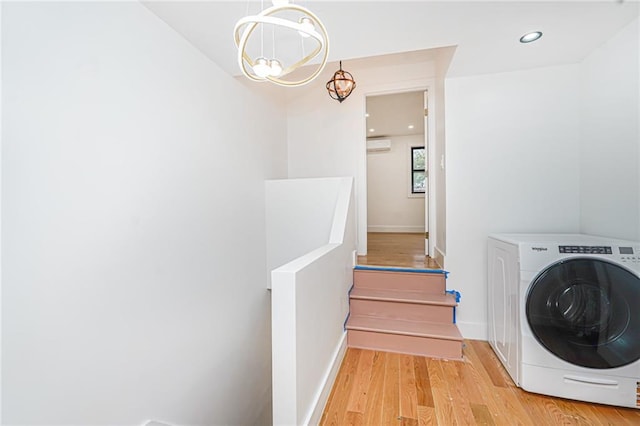 590 E 83rd St, Brooklyn, NY 11236 - laundry room with washer / dryer, light wood-style floors, a chandelier, an AC wall unit, and recessed lighting