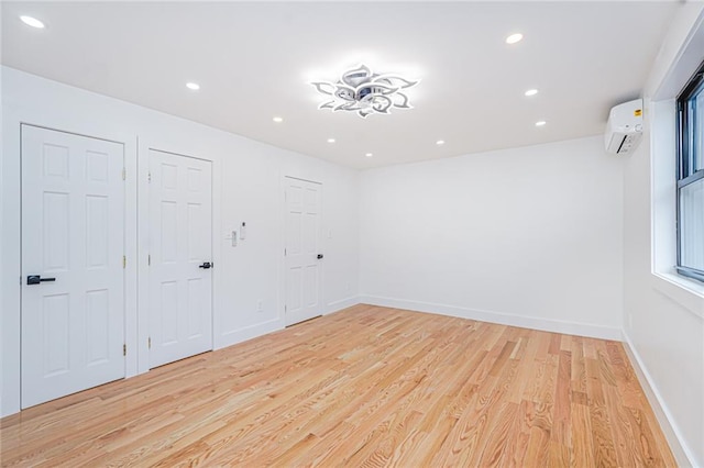590 E 83rd St, Brooklyn, NY 11236 - empty room featuring a wall mounted AC, light wood-style floors, and recessed lighting