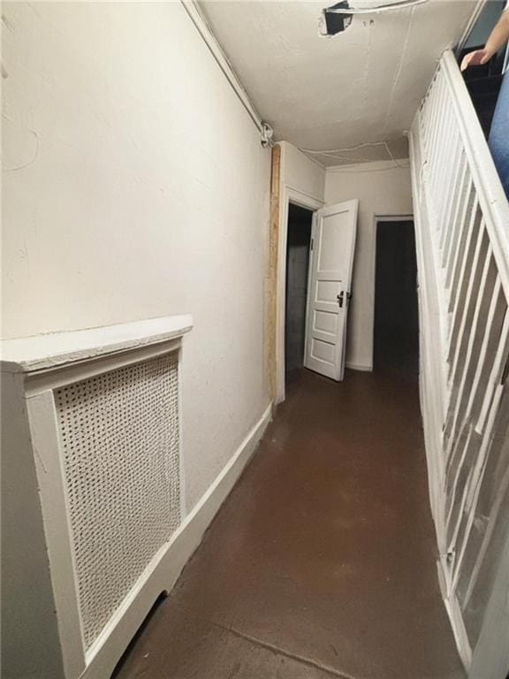 2169 E 3rd St, Brooklyn, NY 11223 - hallway with baseboards and concrete floors