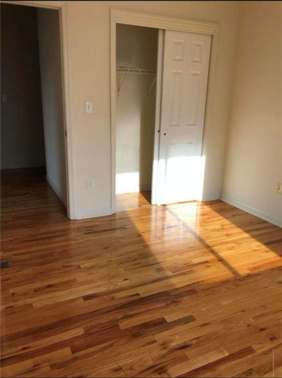 134 S Ave, Staten Island, NY 10303 - unfurnished bedroom with a closet and wood finished floors