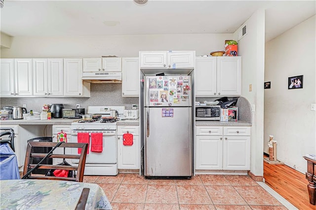 134 S Ave, Staten Island, NY 10303 - kitchen featuring appliances with stainless steel finishes, under cabinet range hood, light countertops, and white cabinets