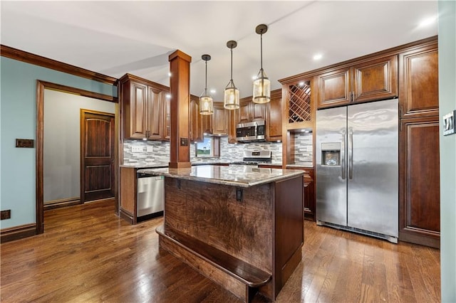 9430 Ridge Blvd Unit 4E, Brooklyn, NY 11209 - kitchen with appliances with stainless steel finishes, light stone counters, backsplash, dark wood-style flooring, and a center island