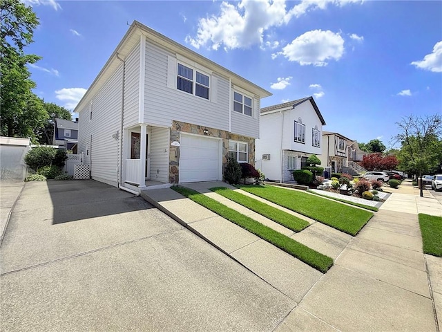 143 Getz Ave, Staten Island, NY 10312 - view of front of house featuring driveway, a garage, stone siding, and a front yard
