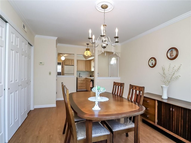 143 Getz Ave, Staten Island, NY 10312 - dining space with light wood-style floors, crown molding, and a chandelier