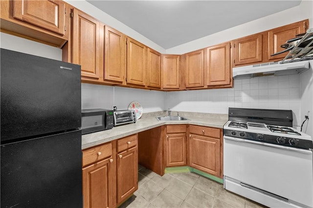 1240 Bedford Ave Unit 1H, Brooklyn, NY 11216 - kitchen featuring freestanding refrigerator, white range with gas stovetop, under cabinet range hood, and light countertops