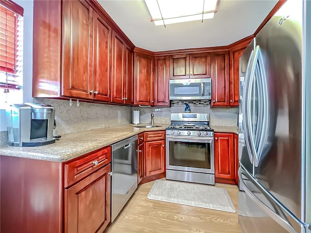 5 Greaves Ave, Staten Island, NY 10308 - kitchen featuring appliances with stainless steel finishes, reddish brown cabinets, and decorative backsplash