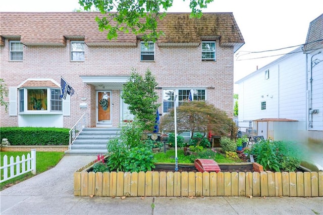 15 Allison Pl, Staten Island, NY 10306 - view of front facade with brick siding, a shingled roof, and mansard roof