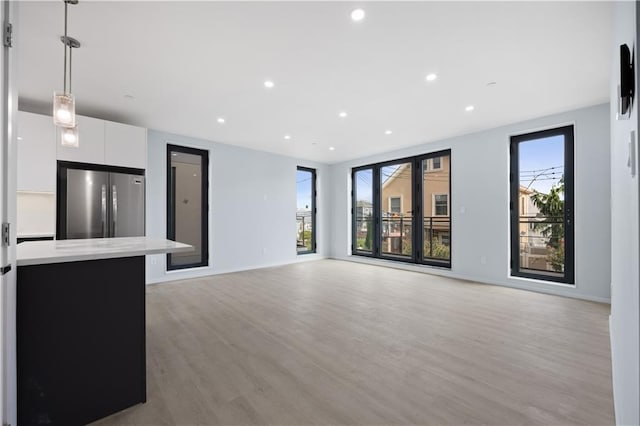 33A Keen Ct, Brooklyn, NY 11229 - unfurnished living room featuring light wood-style floors and recessed lighting