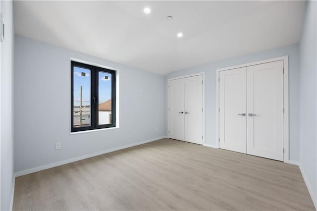 33A Keen Ct, Brooklyn, NY 11229 - unfurnished bedroom with multiple closets, light wood finished floors, vaulted ceiling, and recessed lighting