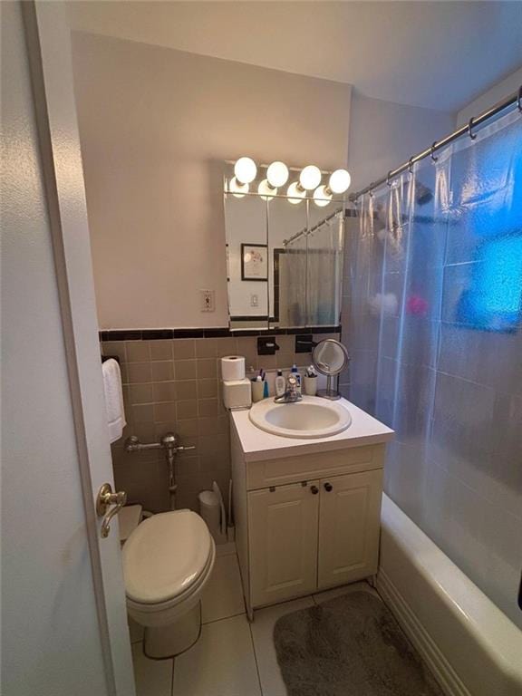 2250 Brigham St Unit 3C, Brooklyn, NY 11229 - bathroom with tile patterned floors, vanity, shower / bath combo, tile walls, and a wainscoted wall