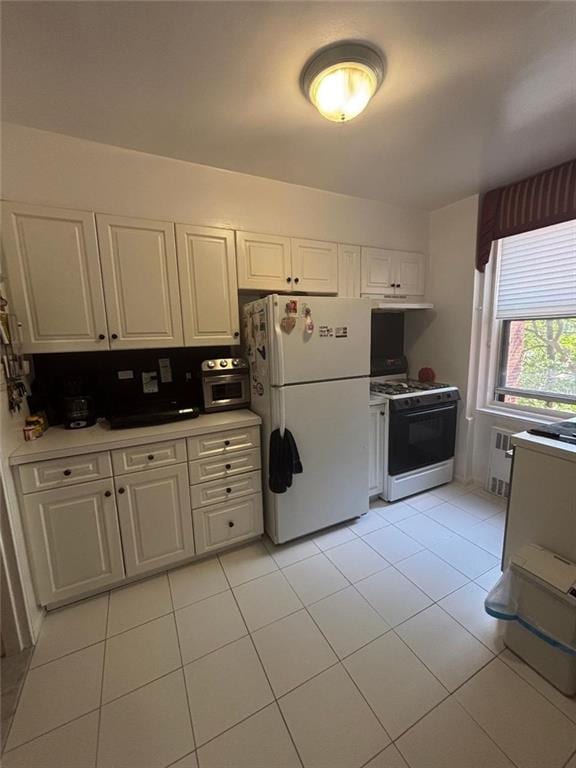 2250 Brigham St Unit 3C, Brooklyn, NY 11229 - kitchen featuring white appliances, white cabinetry, and light tile patterned flooring