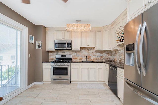 172 Rosedale Ave, Staten Island, NY 10312 - kitchen featuring stainless steel appliances, backsplash, a chandelier, and dark stone countertops