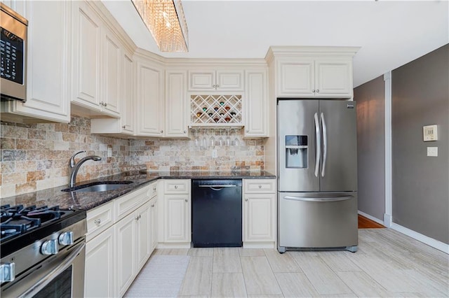 172 Rosedale Ave, Staten Island, NY 10312 - kitchen featuring stainless steel appliances, dark stone countertops, decorative backsplash, and light wood-type flooring