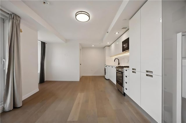 623 H Ave Unit 7C, New York, NY 11230 - corridor featuring light wood-style floors, recessed lighting, and washer / dryer