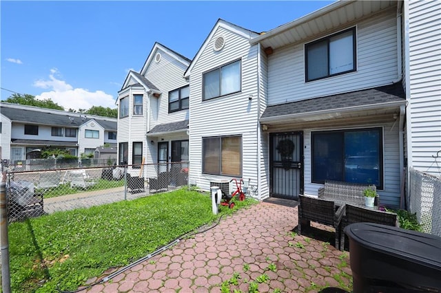 300A Andros Ave, Staten Island, NY 10303 - rear view of house featuring a shingled roof and a patio area