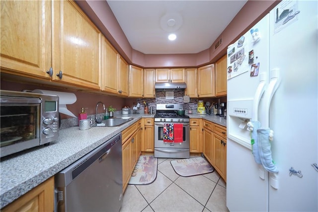 300A Andros Ave, Staten Island, NY 10303 - kitchen with appliances with stainless steel finishes, under cabinet range hood, light tile patterned floors, light countertops, and backsplash