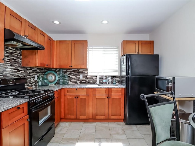 54 Poplar Ave, Staten Island, NY 10309 - kitchen with black appliances, under cabinet range hood, light stone countertops, decorative backsplash, and light marble finish flooring