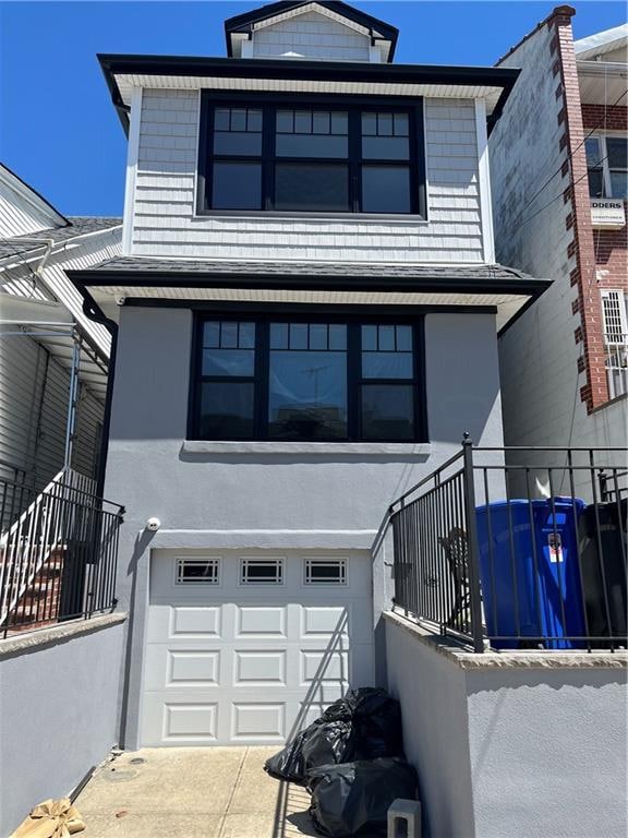 1661 W 5th St, Brooklyn, NY 11223 - american foursquare style home featuring an attached garage and stucco siding