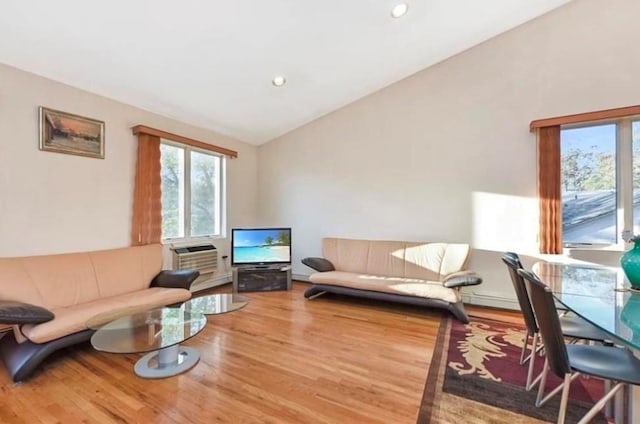 4817 Bedford Ave Unit 3A, Brooklyn, NY 11235 - living area with plenty of natural light, wood finished floors, vaulted ceiling, recessed lighting, and a wall unit AC