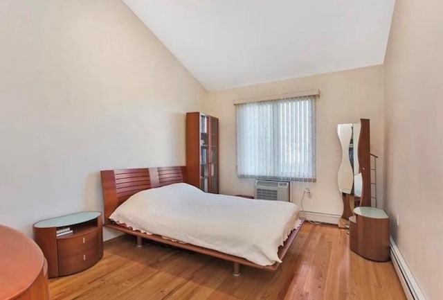 4817 Bedford Ave Unit 3A, Brooklyn, NY 11235 - bedroom with baseboard heating, vaulted ceiling, wood finished floors, and a baseboard heating unit
