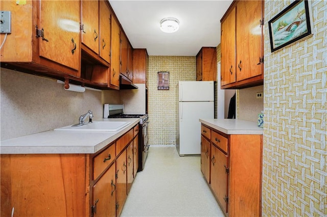 1935 Shore Pkwy Unit 8E, Brooklyn, NY 11214 - kitchen with freestanding refrigerator, black range with gas cooktop, light countertops, and brown cabinets
