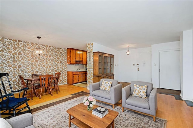 1935 Shore Pkwy Unit 8E, Brooklyn, NY 11214 - living area with light wood finished floors, wallpapered walls, and a chandelier